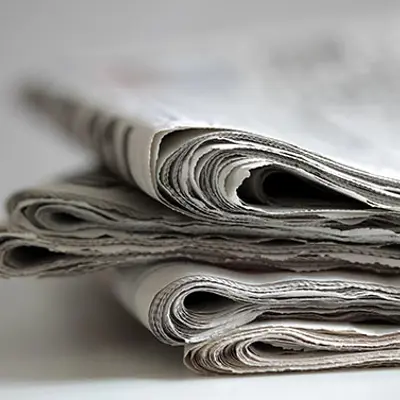 a stack of folded newspapers